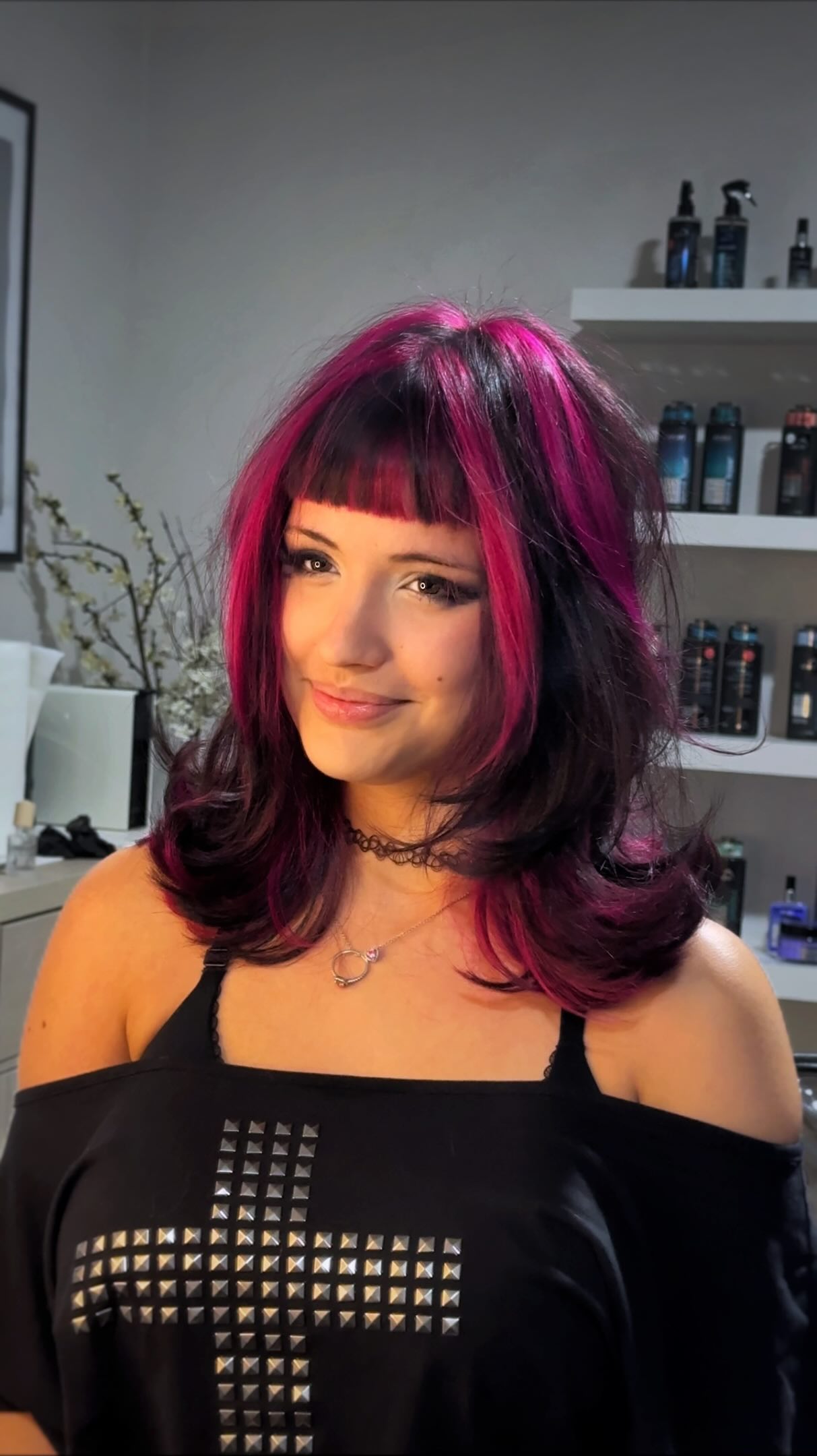 Client with vivid magenta hair color, micro fringe and a bright money piece, in the CRIS HAIR studio in Malden