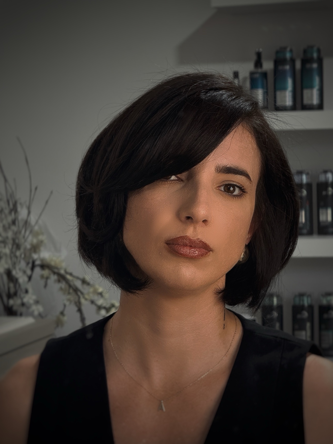 Client with a polished dark preppy bob at CRIS HAIR in Malden