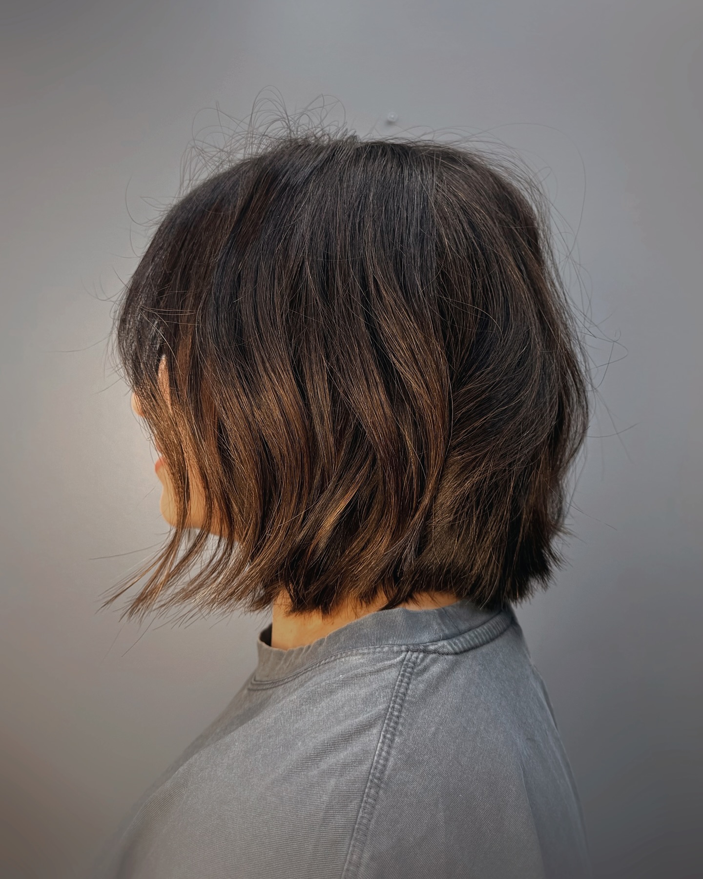Dark textured bob haircut, back view